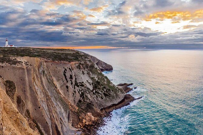 Arrábida / Setúbal Private Tour <em> Private Tours </em> – Cabo Espichel: Limestone Cliffs and a Monument Built for Faith’ /><br />
At <strong>Cabo Espichel</strong>, you’ll have about an hour. This is where the day gets more architectural and more layered.</p>
<p><p>The sanctuary there is described as a unique civil-and-religious architectural ensemble. In plain terms: it’s not only a church. It’s a monumental building placed on a plateau that ends in escarpments to the sea, so the location does part of the storytelling. The setting turns the structure into a landmark you feel in your bones, not just see.</p>
</p>
<p><p>Why this stop is valuable: it shows you how coastal Portugal thinks about devotion and geography at the same time. You’re not just looking at scenery; you’re seeing how people built meaning into a place that also happens to be visually dramatic.</p>
</p>
<p><p>Possible drawback: if you prefer beaches and towns over architecture, this might feel more “looking and reading” than “doing.” The good news is the day balances it with places like Sesimbra and Portinho da Arrábida.</p>
</p>
<h2 id="sesimbra-castle-and-village-old-walls-real-streets-easy-wandering">Sesimbra Castle and Village: Old Walls, Real Streets, Easy Wandering</h2>
<p> Private Tours </em> – Sesimbra Castle and Village: Old Walls, Real Streets, Easy Wandering’ /><br />
Sesimbra is next, and you get about 1 hour 30 minutes. That’s enough time to do two good things without feeling rushed:</p>
<p><p>1) see the <strong>castle</strong> area</p>
</p>
<p><p>2) wander into the <strong>village</strong> for street life</p>
</p>
<p><p>Admission is listed as free for this stop, which helps you enjoy the time without counting costs.</p>
</p>
<p><p>What makes Sesimbra work on this route is contrast. You’ve been on big-view platforms and cliff areas, then you step into a town with slower rhythms. Even if you don’t go deep into historic details, you can still appreciate how the place is shaped for coastal living.</p>
</p>
<p><p>How to use your time well:</p>
</p>
<ul>
<li>Start with the higher spot or castle area first, while you have energy for walking and views.</li>
<li>Then move toward the village level for a calmer pace, snacks, and people-watching.</li>
<li>Don’t try to cover every street. In places like this, the best moments happen when you choose one direction and let yourself get slightly lost.</li>
</ul>
<h2 id="portinho-da-arrabida-beach-time-in-the-natural-park">Portinho da Arrábida: Beach Time in the Natural Park</h2>
<p><img width="669" height="446" decoding="async" src=