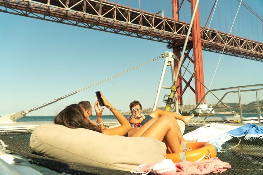Lisbon: Catamaran Boat Party with Music, Open Bar & Dives - The Cruise Starts Smooth: Algés Views From the Water