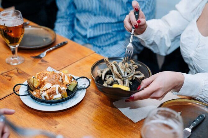 Lisbon Food Tour with Portuguese Wine: Taste the Best of Portugal - Baixa petiscos at Rua dos Fanqueiros: flamed chouriço and codfish à Brás