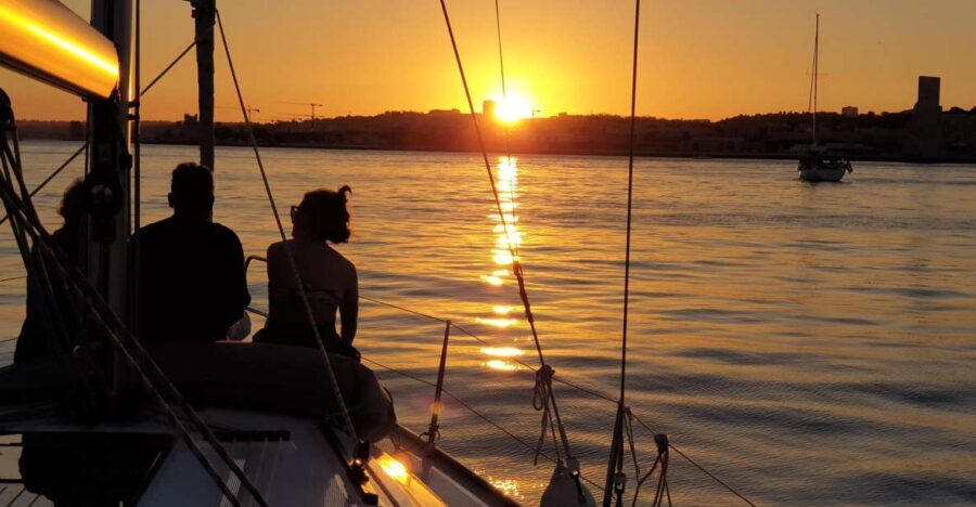 Lisbon: Private Sunset Cruise with Portuguese Wine - Sliding under major bridges and toward Cristo Rei vibes